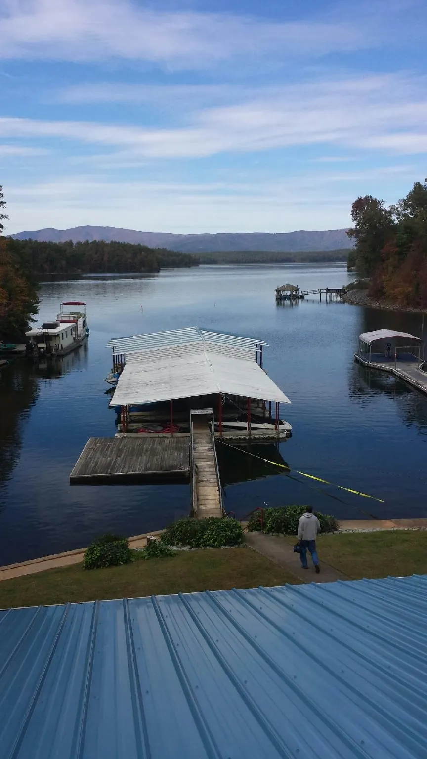 View across a lake from a newly installed blue metal roof in Hastings